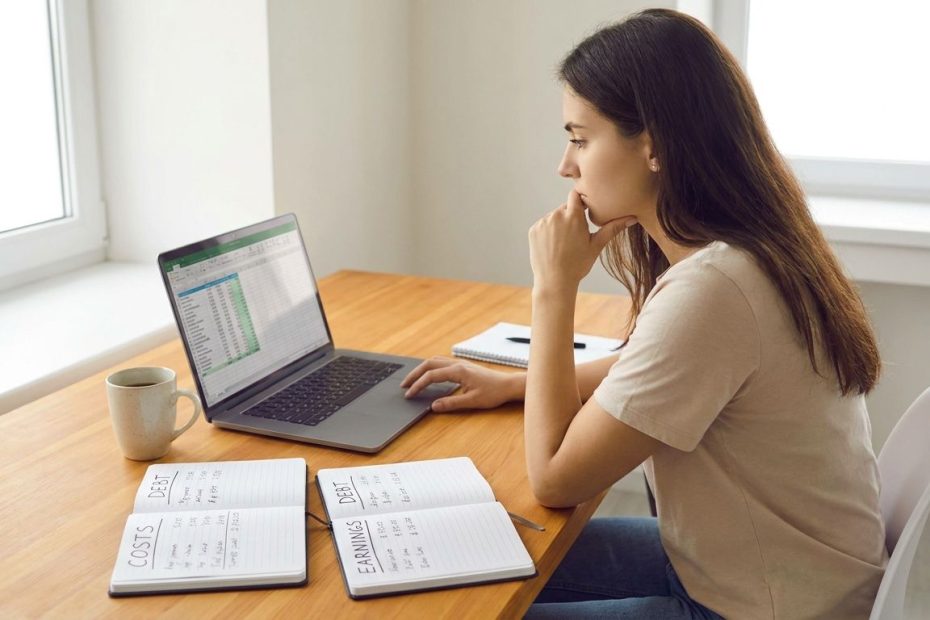 Graduate student reviewing tuition costs and salary payoff on a laptop